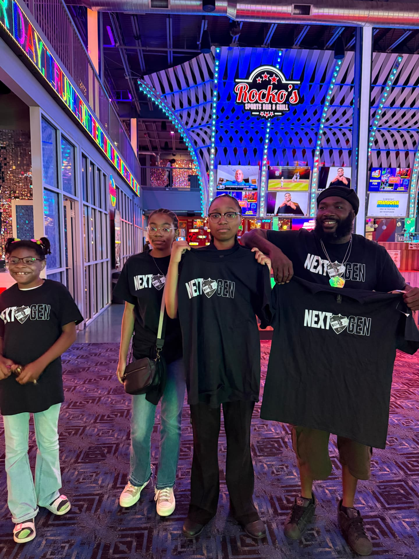 Next Gen members receiving program apparel at a community event